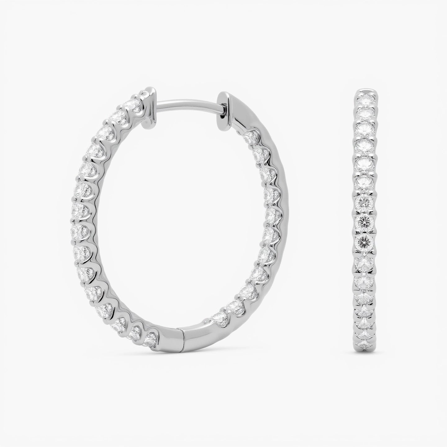 Crafted in 14K/18K gold or platinum, these inside-out hoops feature 2.00 ctw lab grown diamonds, prong-set with hinged snap closure and rhodium finish | Adorn By You