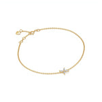 One bracelet of delicate yellow gold chain features a small four-petal star of white marquise-cut stones set in prongs at its center, with a spring-ring clasp and a tiny heart tag saying Adorn By You on the extender. The piece is laid flat against a seamless white background under soft, even lighting in a high-key, top-down composition. The polished gold tones and sparkling gemstones are sharply in focus, giving the image a crisp, professional product-shot style. | Adorn By You
