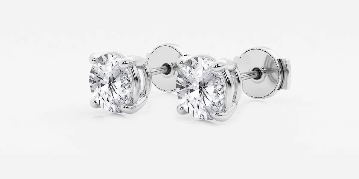 Lab-grown round diamond solitaire studs in 14K/18K gold. VS clarity, 0.25–6 CTW, four-prong, screw-back | Adorn By You