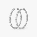 These inside-out hoop earrings feature 40 round lab grown diamonds totaling 2.00 carats, prong-set for optimal visibility. Crafted in 14K or 18K gold and platinum, they measure 0.84 inches in length and 0.08 inches in width, finished with a hinged snap closure | Adorn By You