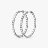 These inside-out hoop earrings feature 40 round lab grown diamonds totaling 2.00 carats, prong-set for optimal visibility. Crafted in 14K or 18K gold and platinum, they measure 0.84 inches in length and 0.08 inches in width, finished with a hinged snap closure | Adorn By You