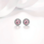 Pair of earrings with pink gemstones on a light background