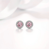 Pair of earrings with pink gemstones on a light background